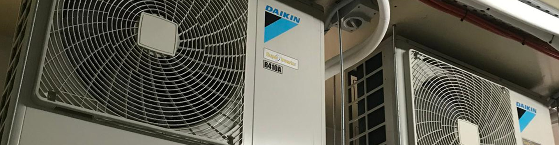 Daikin VRV/VRF outdoor condenser units with copper piping mounted on ceiling bracket indoors