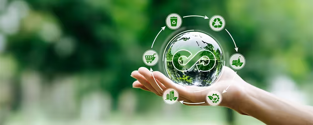 Hand holding a glass globe with a recycling symbol, surrounded by sustainability icons, representing eco-friendly air conditioning