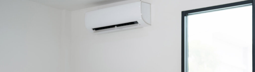Wall-mounted split air conditioner unit near ceiling, relevant to ac not working issues